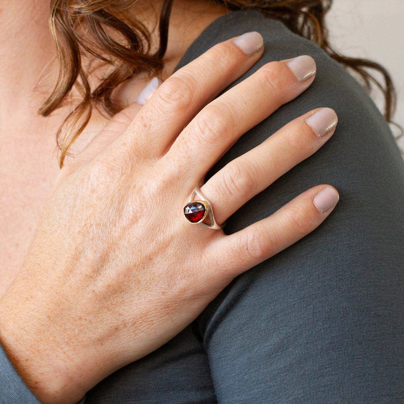 Red Tourmaline Silver and Gold Cleo Ring modeled on a hand