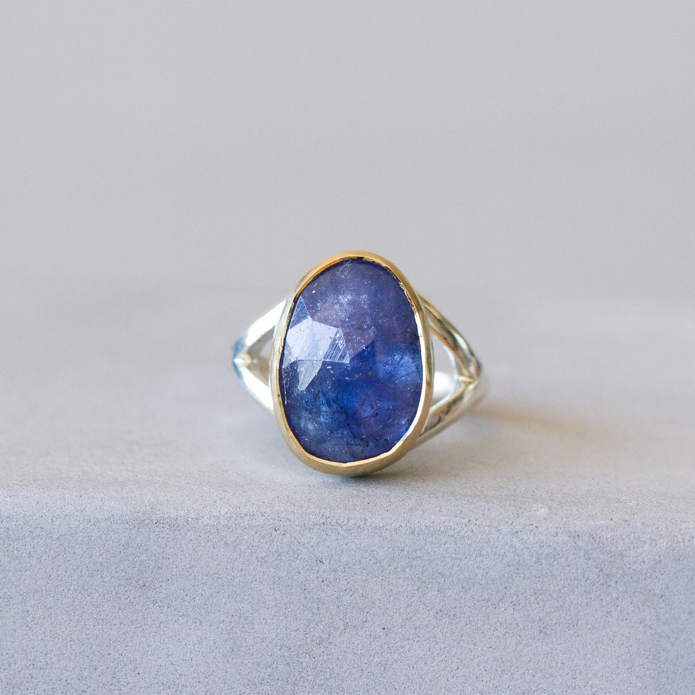 Tanzanite Silver and Gold Cleo Ring on a plain background, front angle