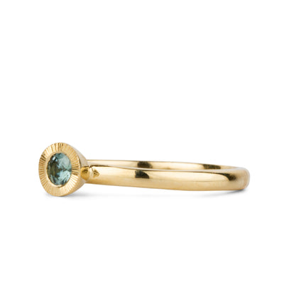 Teal Montana Sapphire Large Aurora Stacking Ring in Yellow Gold on a white background, side angle