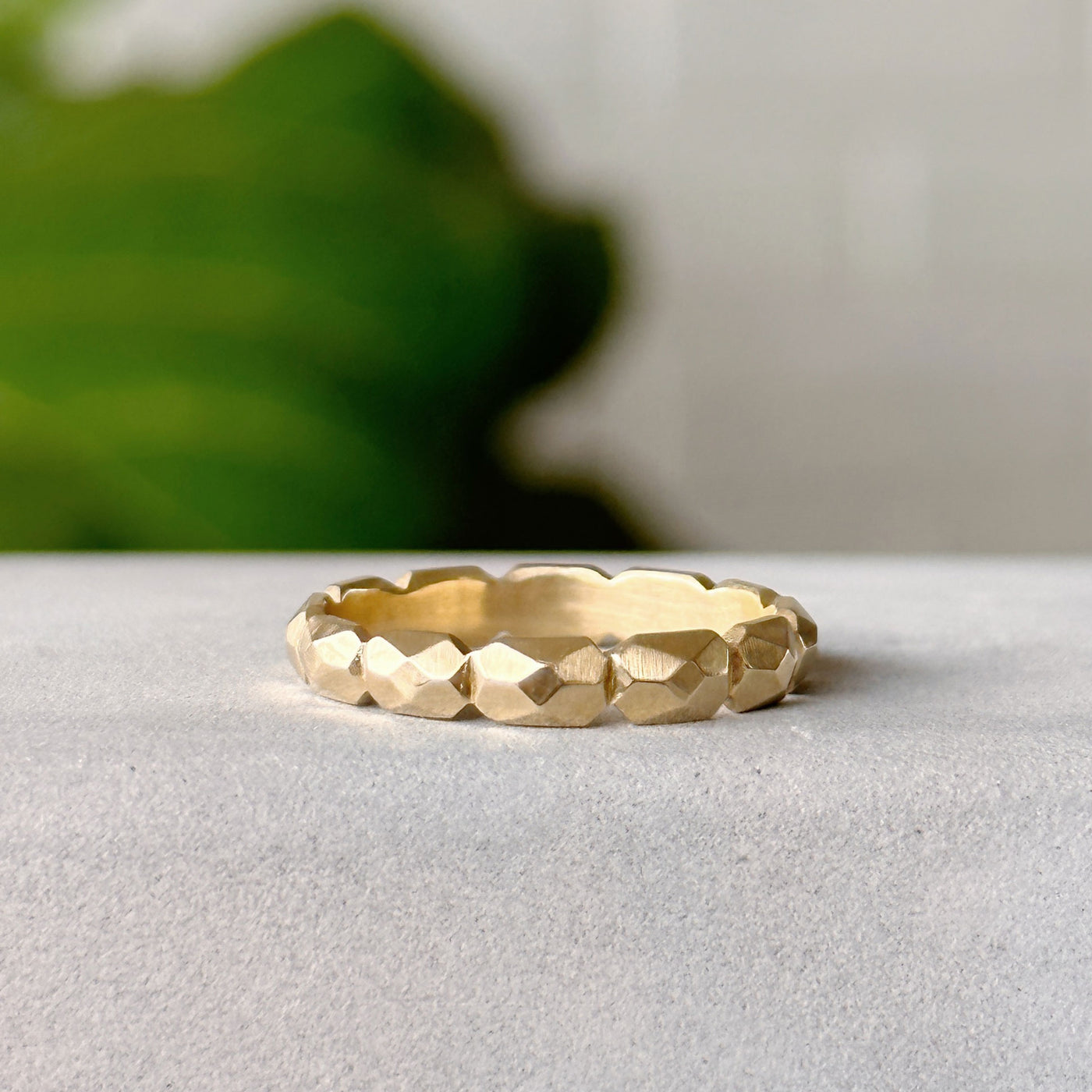 Fragment Eternity Band in Yellow Gold on a neutral gray background 