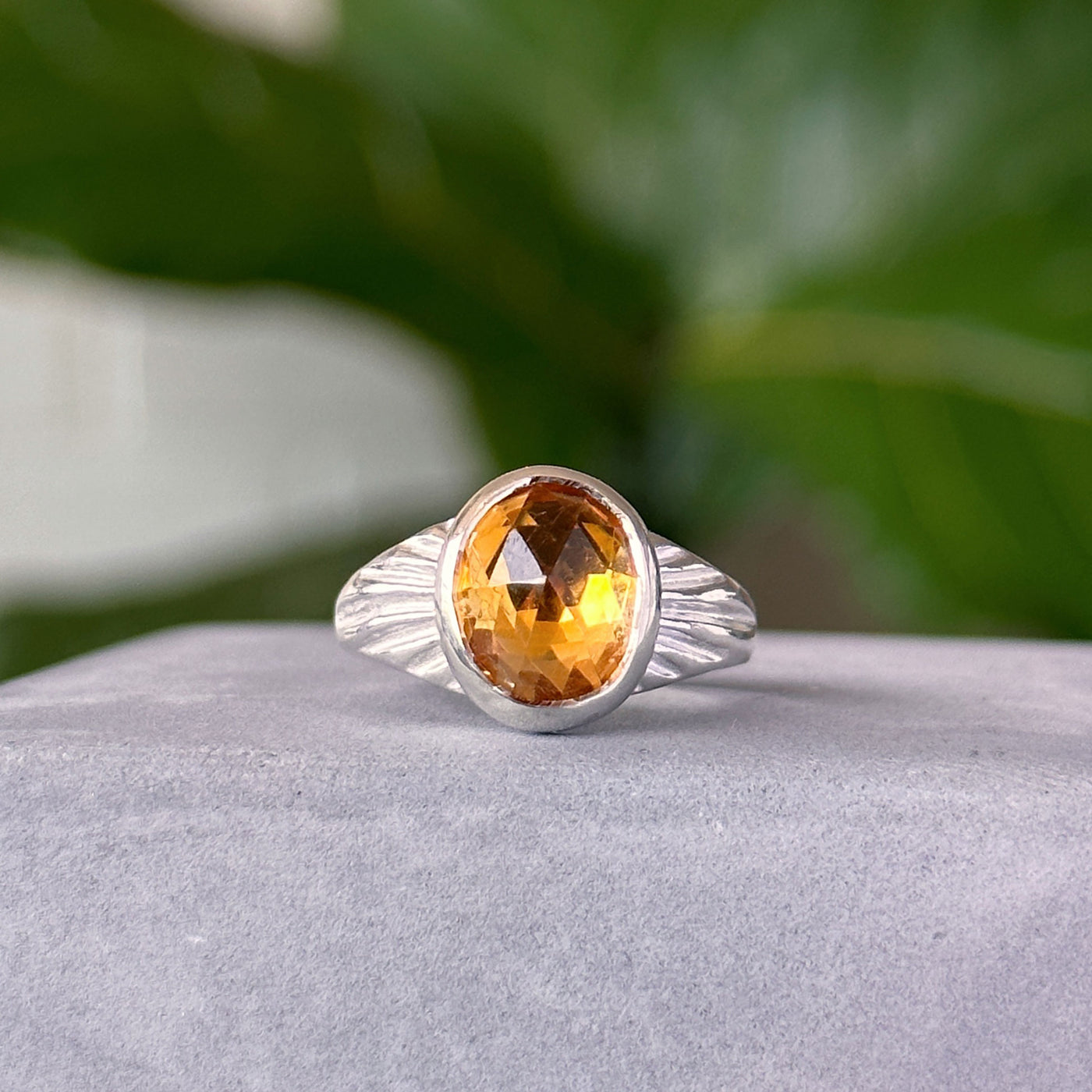 Citrine Calista Ring in Sterling Silver sitting on a cement table, front angle