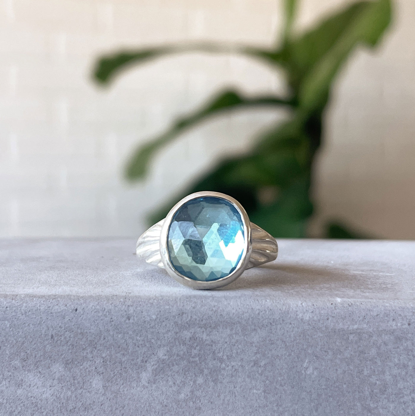 Swiss Blue Topaz Calista Ring in Sterling Silver #1 on a concrete table, front angle