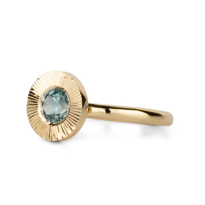Green Montana Sapphire Aurora Solitaire on a white background, side angle