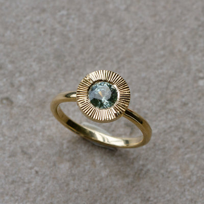 Green Montana Sapphire Aurora Solitaire .95ct on a neutral background, front angle