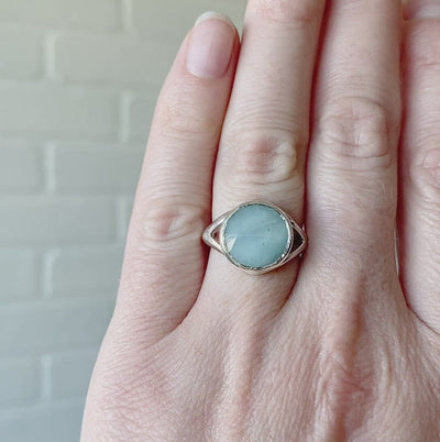 Round rose cut opaque aquamarine split-shank sterling silver Cleo Ring on a hand