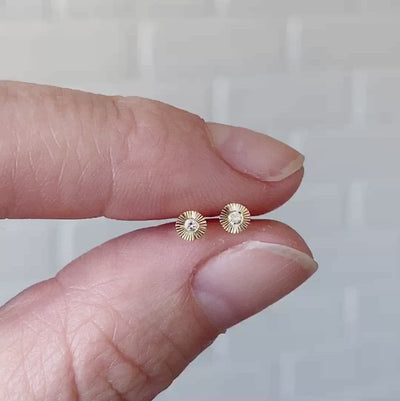 14k yellow gold micro aurora stud earrings with diamond centers and an engraved halo border