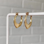 14k yellow gold hinged hoop earrings with carved sunburst motif