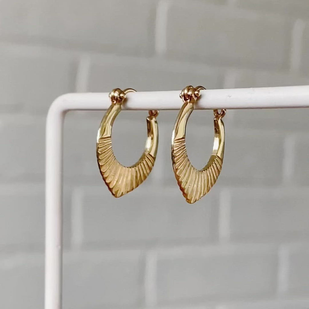 14k yellow gold hinged hoop earrings with carved sunburst motif