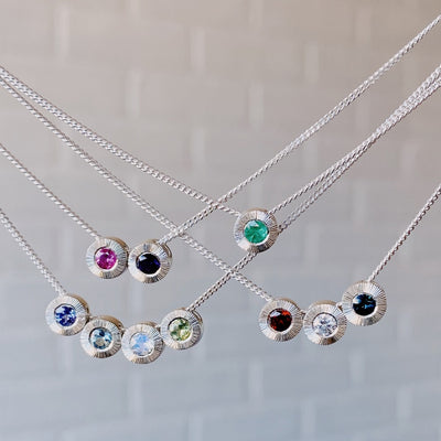 Sterling silver birthstone Aurora pendants on chains in clusters of 1, 2, 3, and 4 pendants per chain.