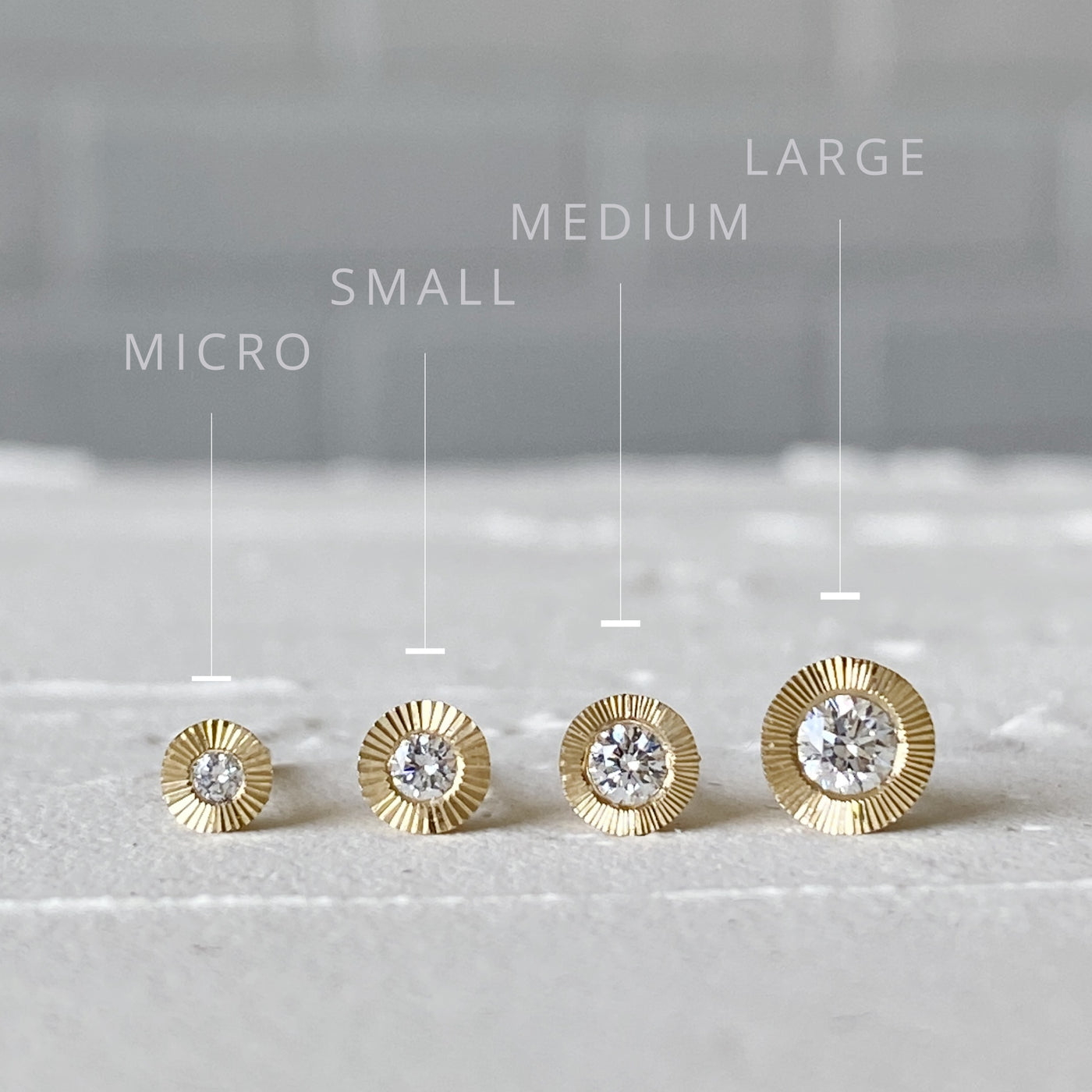 4 Sizes of 14k yellow gold Aurora Stud Earrings from Left to Right: Micro (1.5mm diamond) Small (2mm diamond) Medium (2.5mm diamond) and Large (3mm diamond)