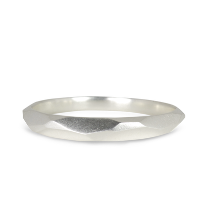 Sterling silver large chunky faceted bangle bracelet by Corey Egan on a white background