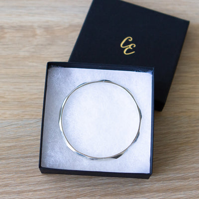 Thin Denali Faceted Bangle in a gift box by Corey Egan