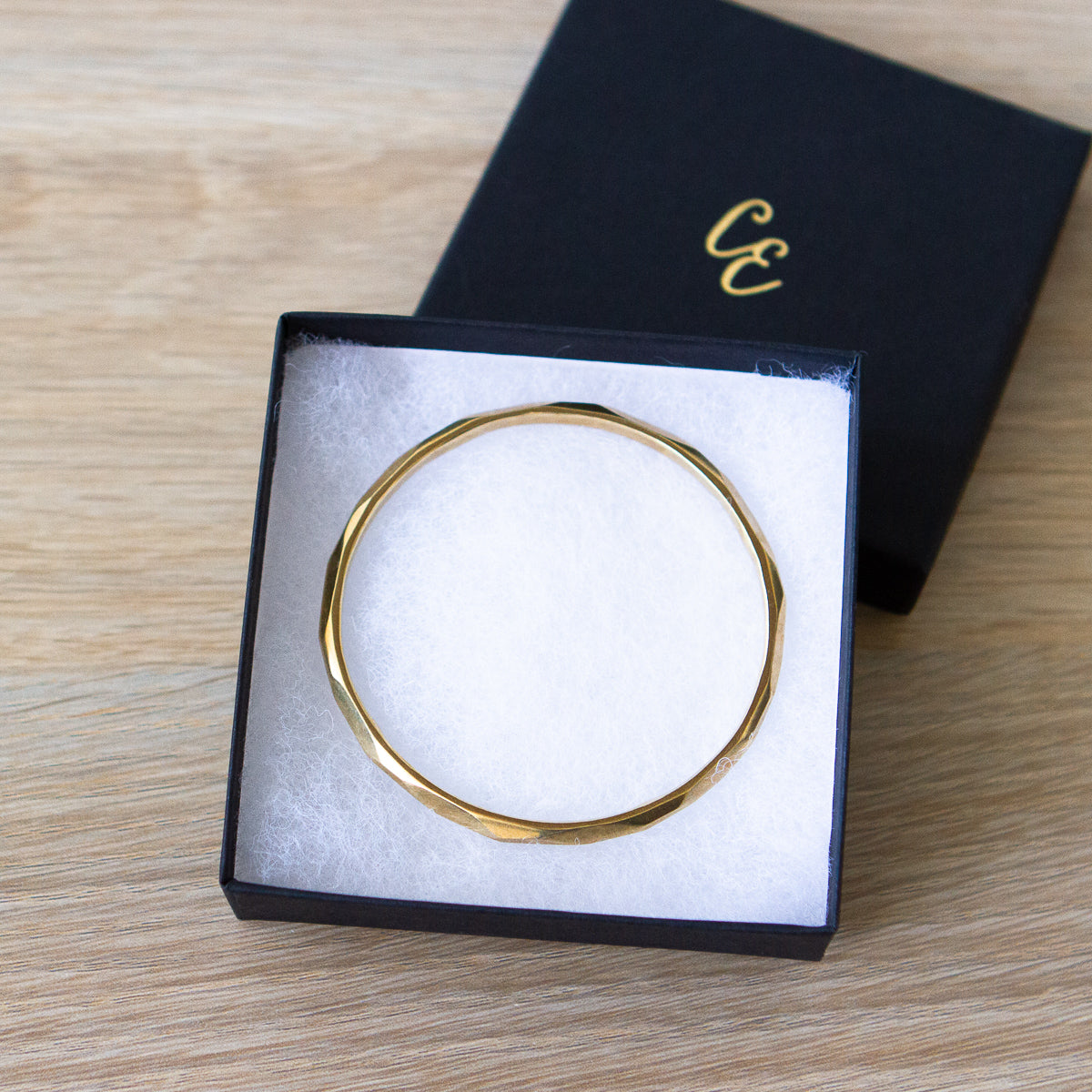 stackable faceted yellow bronze bangle bracelet in a gift box