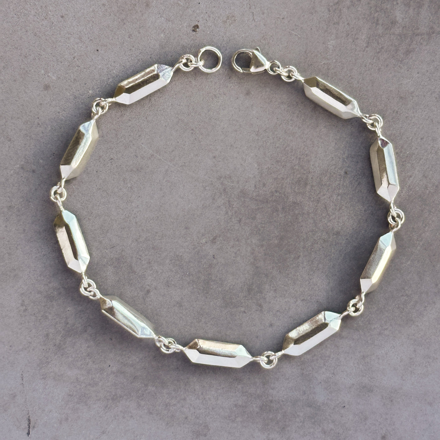 Fragment Link Bracelet in Silver on neutral gray background