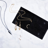 Corey Egan Logo Jewelry Pouch with jewelry scattered around