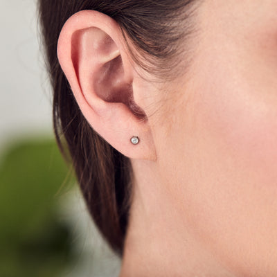 Silver and Diamond Droplet Studs by Corey Egan on an ear