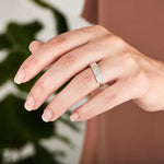 Sterling silver bar ring with three diamonds and a carved sunburst design around each by Corey Egan on a hand