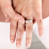 Sterling silver bar ring with three diamonds and a carved sunburst design around each by Corey Egan on a hand vie #2