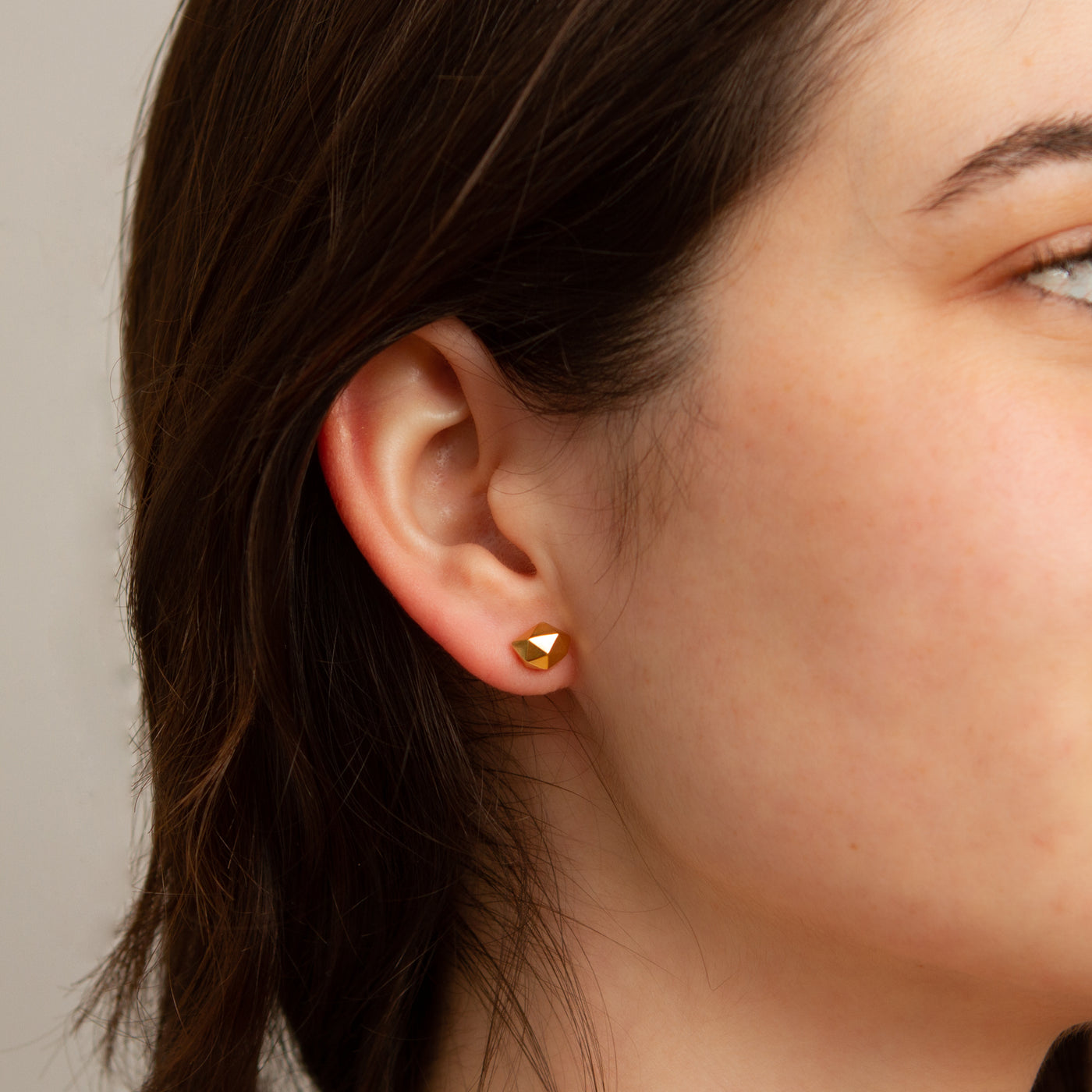 Tiny Fragment Vermeil Stud Earrings on a model, photo 1