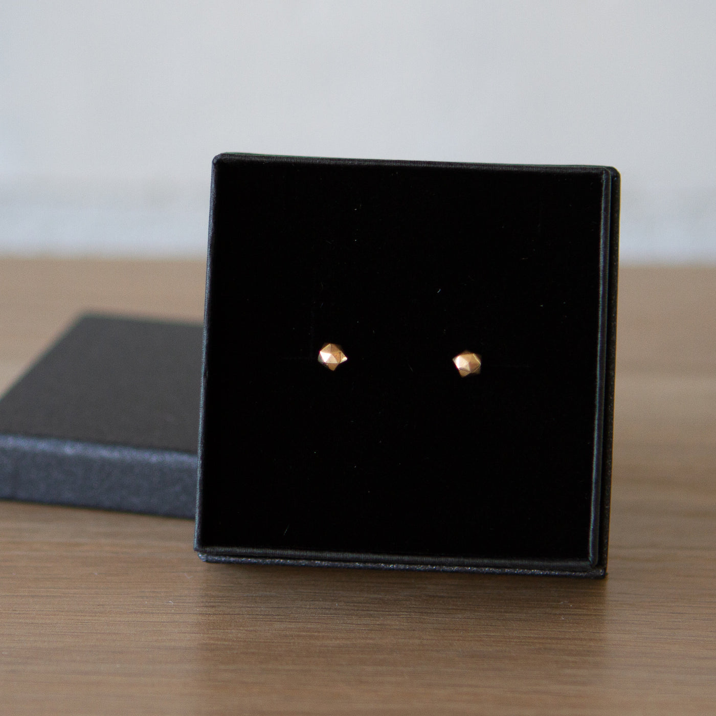 extra small faceted rose gold micro fragment stud earrings in a gift box