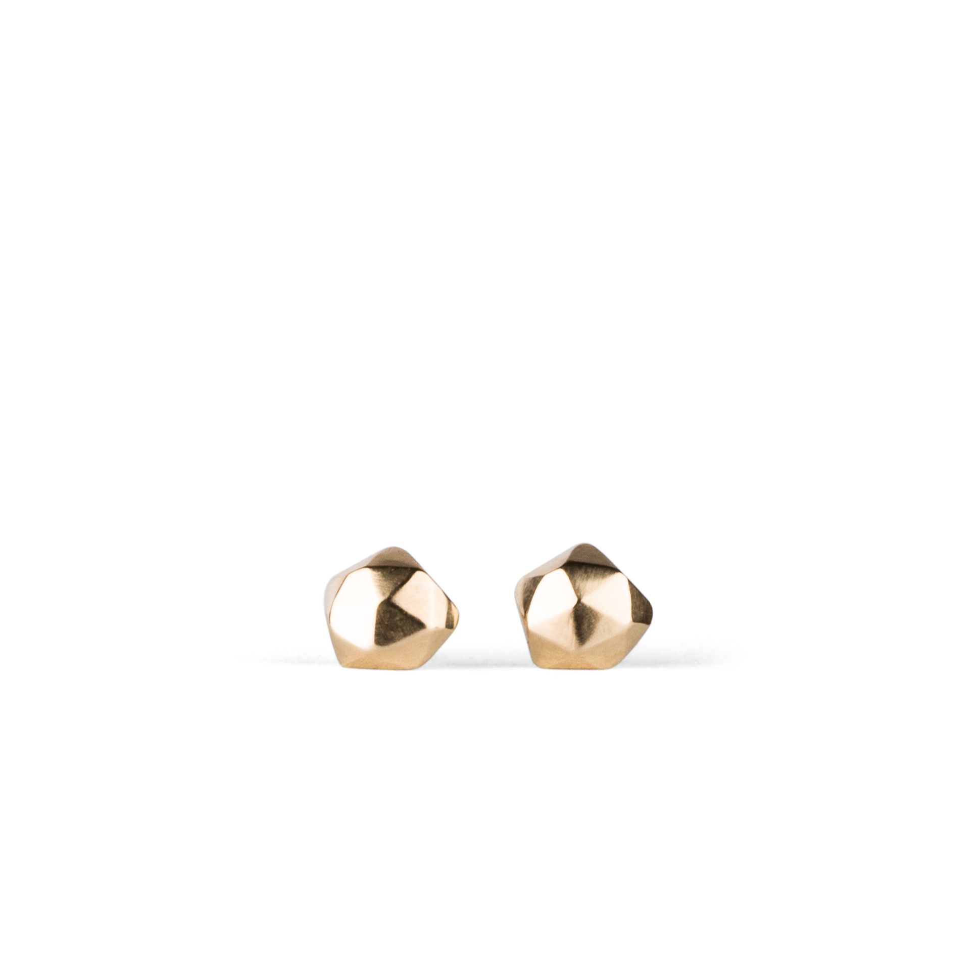 14k yellow gold geometric faceted stud earrings in the micro size on a white background by Corey Egan