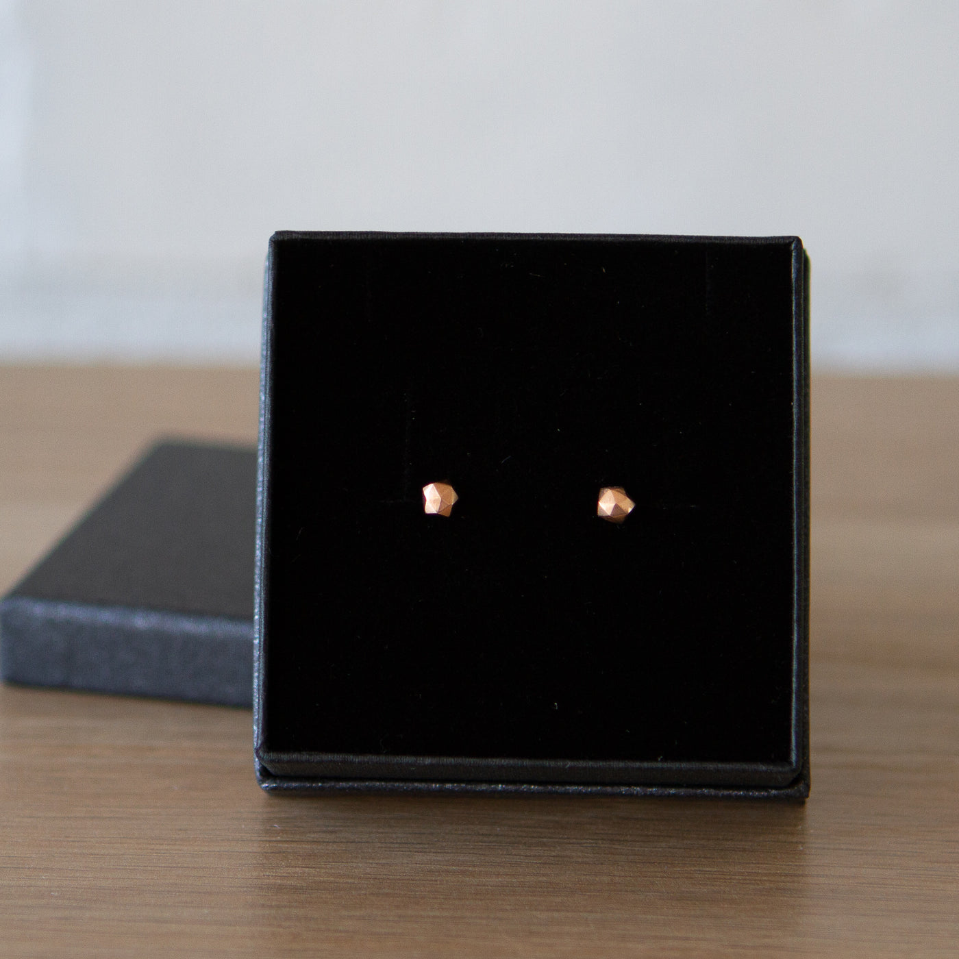 14k yellow gold geometric faceted stud earrings in the micro size in a gift box by Corey Egan