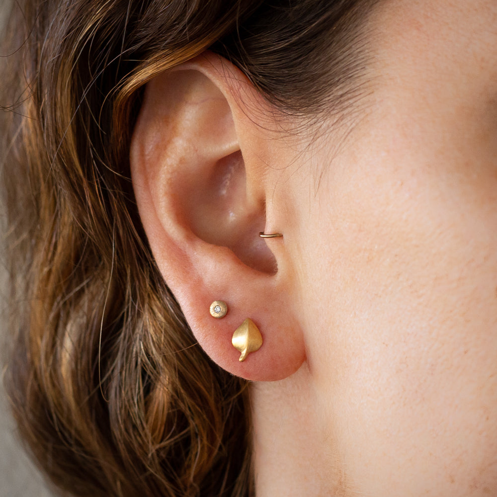 Aspen Leaf Vermeil Stud Earrings on an ear