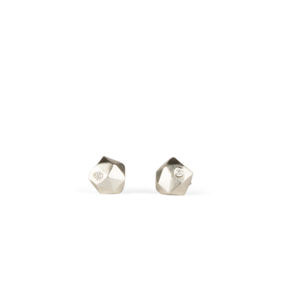sterling silver micro size geometric faceted stud earrings with a single flush set diamond by Corey Egan on a white background