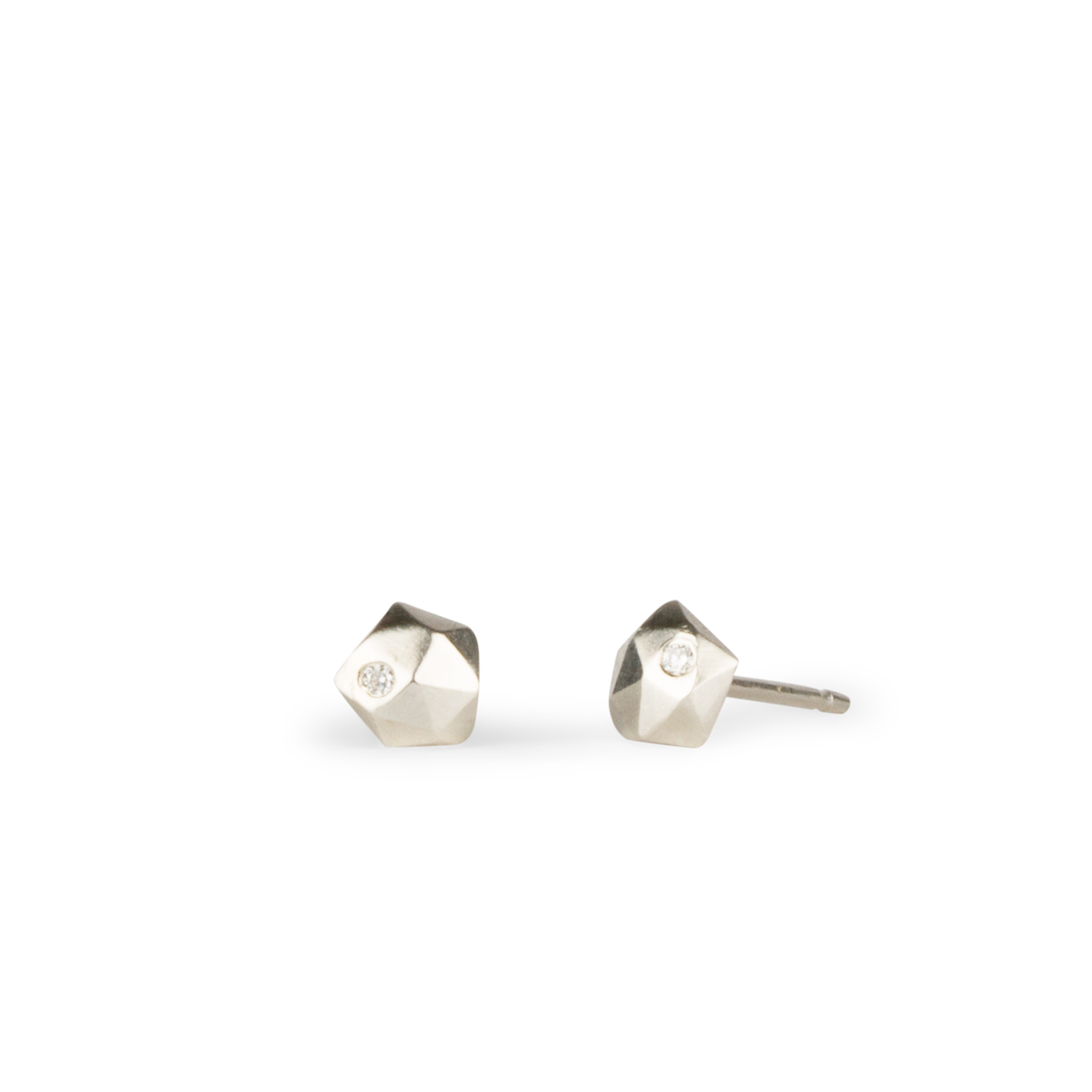 sterling silver micro size geometric faceted stud earrings with a single flush set diamond by Corey Egan on a white background