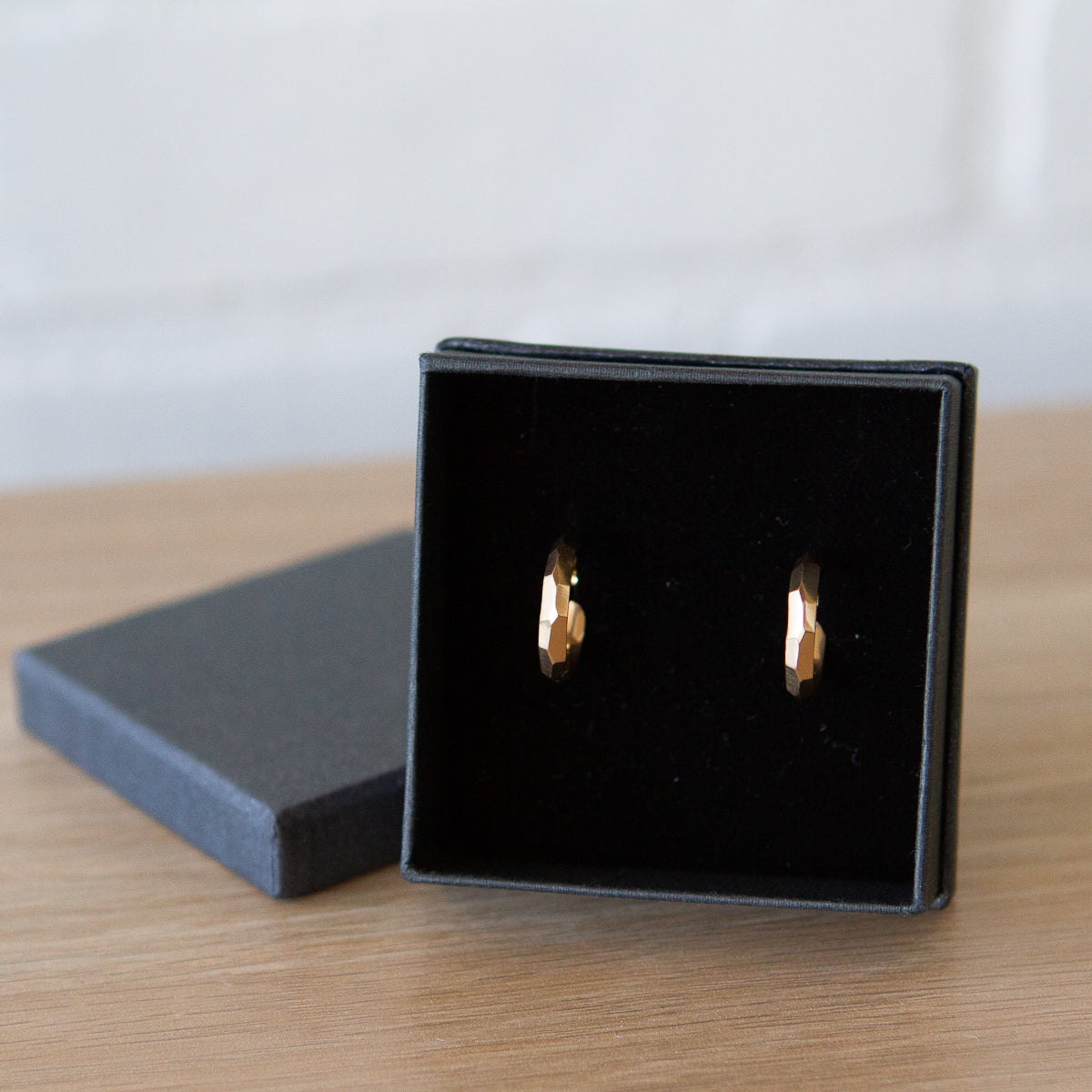 gold faceted denali hoop earrings in a gift box
