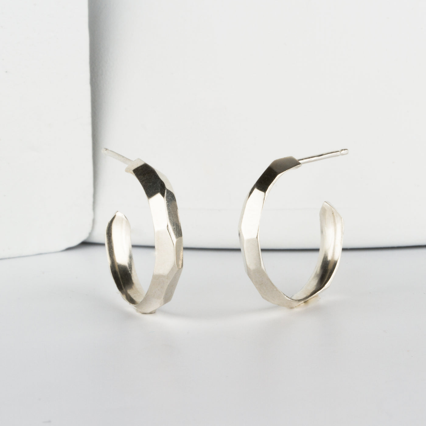 Sterling silver small faceted hoop earrings with posts by Corey Egan