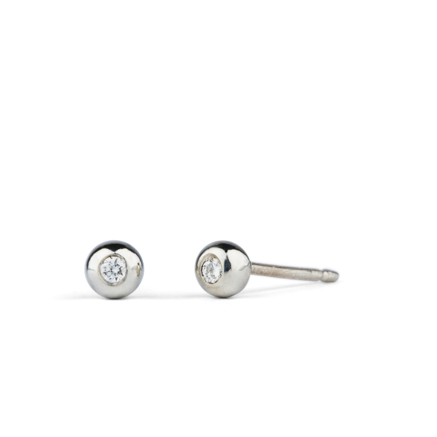 Silver and Diamond Droplet Studs by Corey Egan on a white background side view