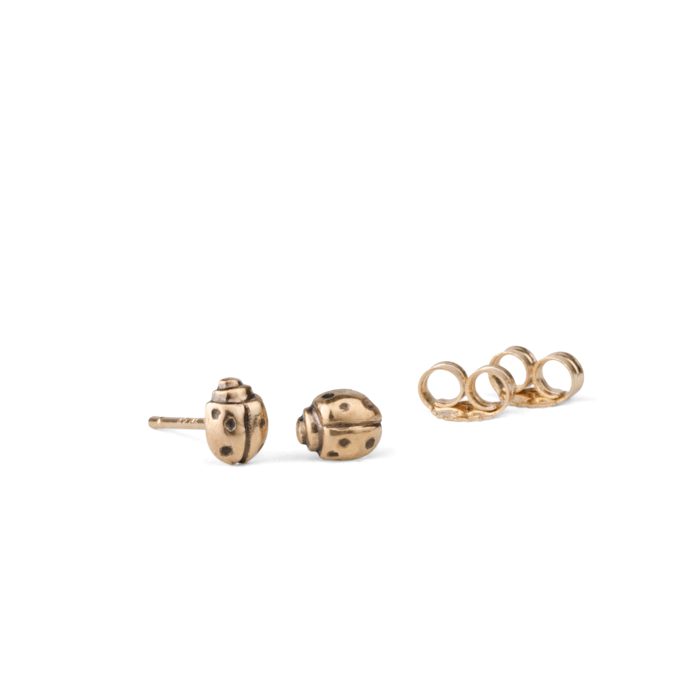 Gold Ladybug Stud Earrings on a white background by Corey Egan
