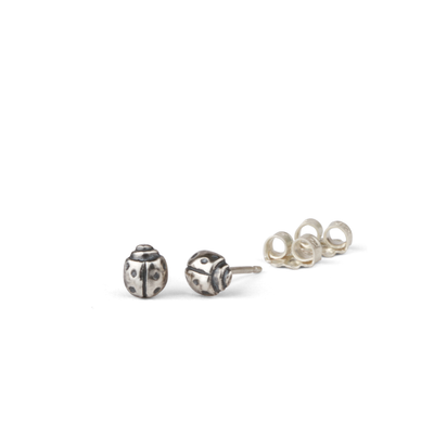 Silver Ladybug Stud Earrings by Corey Egan on a white background side view