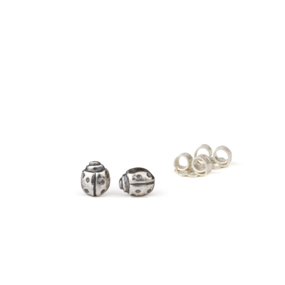 Silver Ladybug Stud Earrings by Corey Egan on a white background