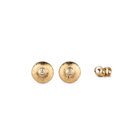 14k yellow gold circle stud earrings with a diamond center and engraved border on a white background by Corey Egan