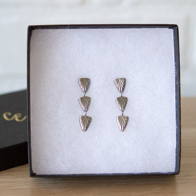 Oxidized silver triple drop earrings of cared triangular sparks with post backs in a gift box