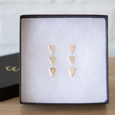 Sterling silver triple drop earrings of cared triangular sparks with post backs in a gift box