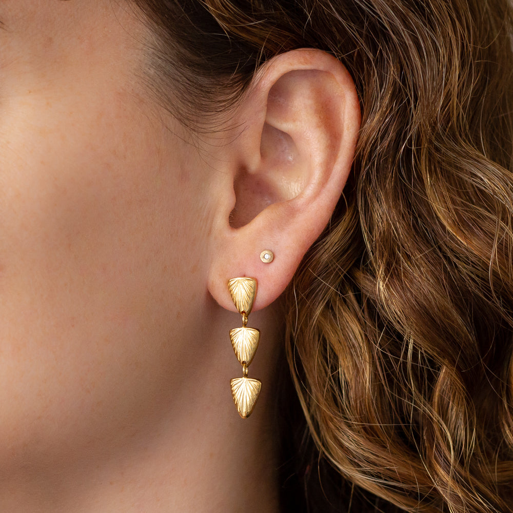 Flicker Vermeil Earrings by Corey Egan on an ear