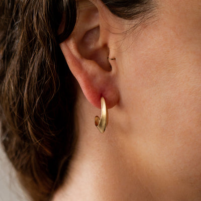 Sculptural Gold Textured Hoop Earrings on an ear