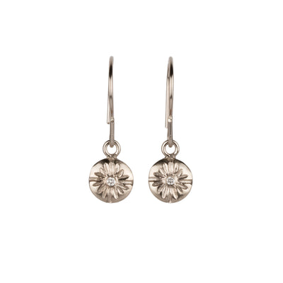 Round Small Lucia dangle earrings in white gold with diamond centers on a white background