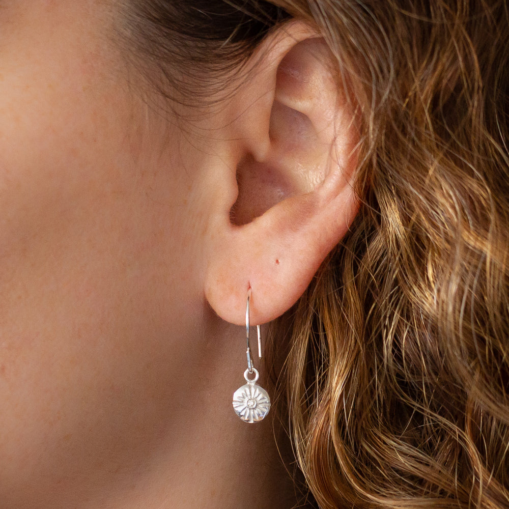 Lucia Small Dangle Earrings in Silver on an ear | Corey Egan