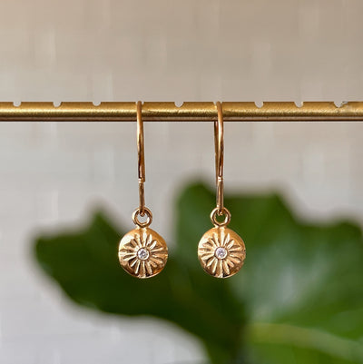 Small Lucia Dangle Vermeil Earrings hanging in front of a white wall, front angle