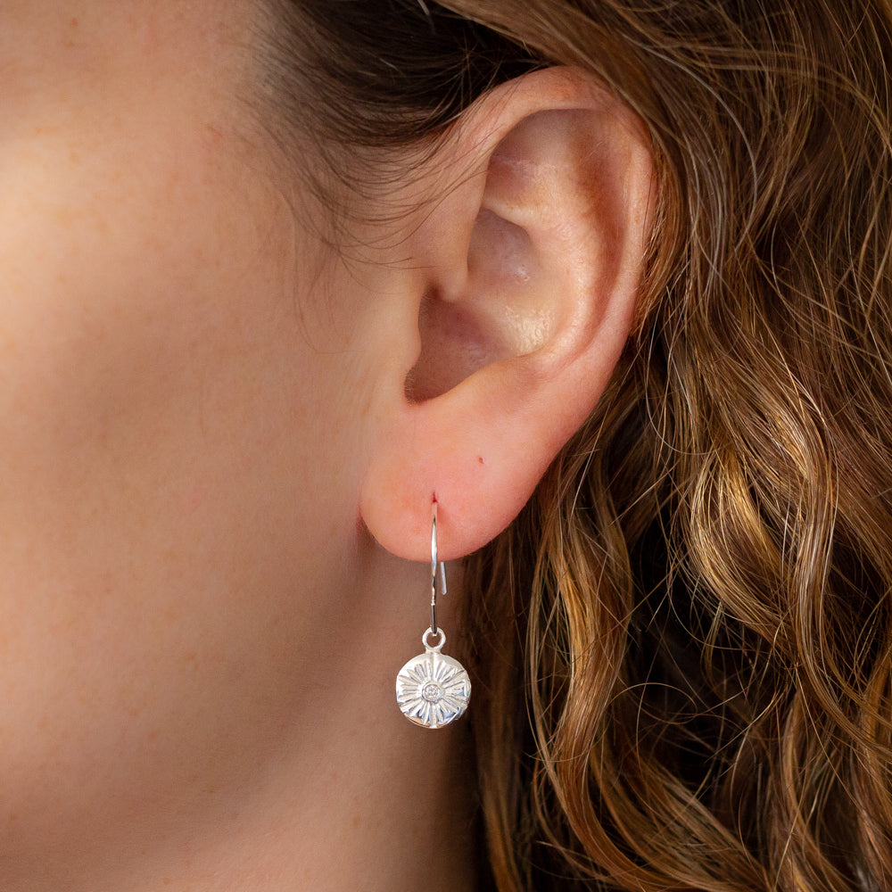 Lucia Medium Diamond Stud Earrings in Silver on an ear | Corey Egan