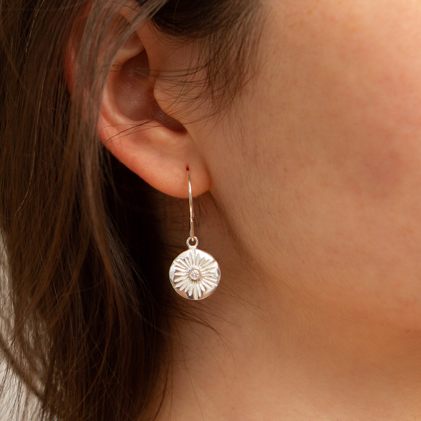 Large Lucia Silver Dangle Earrings modeled on an ear