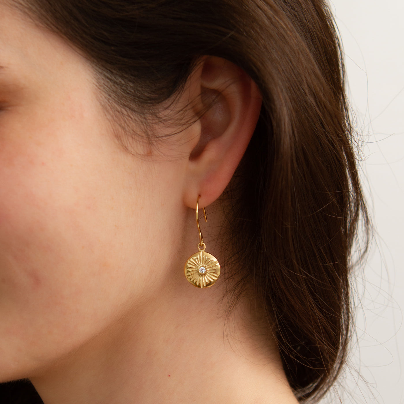 Large Lucia Vermeil Dangle Earrings modeled on an ear