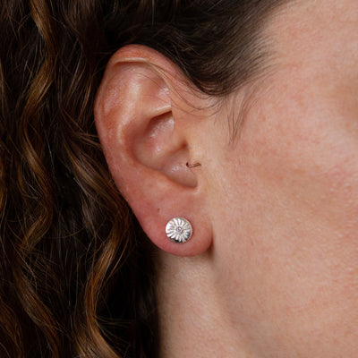 Small Lucia Diamond Stud Earrings on an ear by Corey Egan