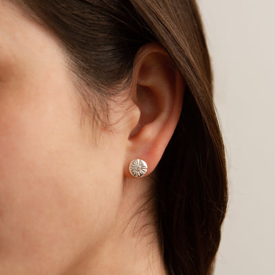 Small Lucia Stud Earrings modeled on an ear