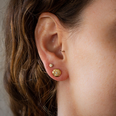 Small Lucia Diamond Vermeil Stud Earrings on an ear by Corey Egan