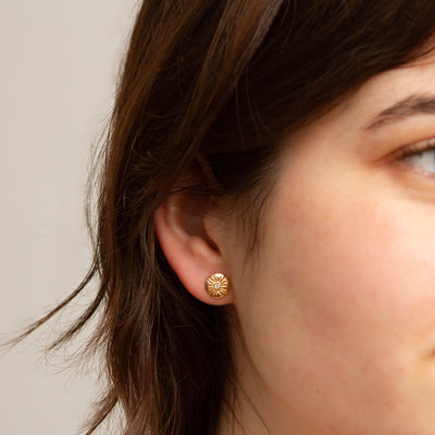 Small Lucia Vermeil Stud Earrings modeled on an ear